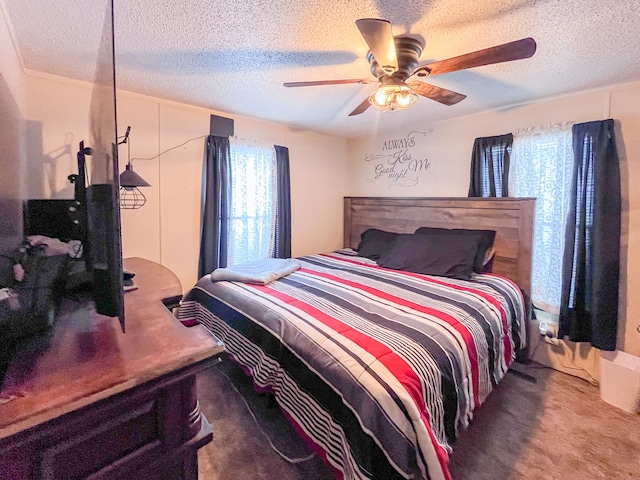 bedroom featuring a textured ceiling, carpet floors, and a ceiling fan