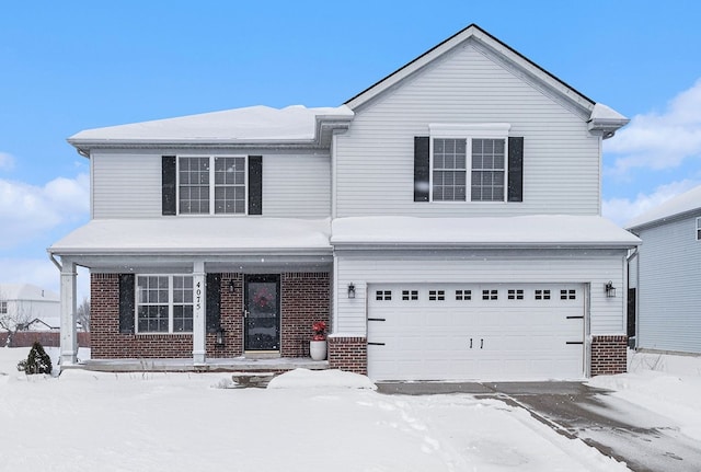 traditional-style home featuring a garage, a porch, and brick siding