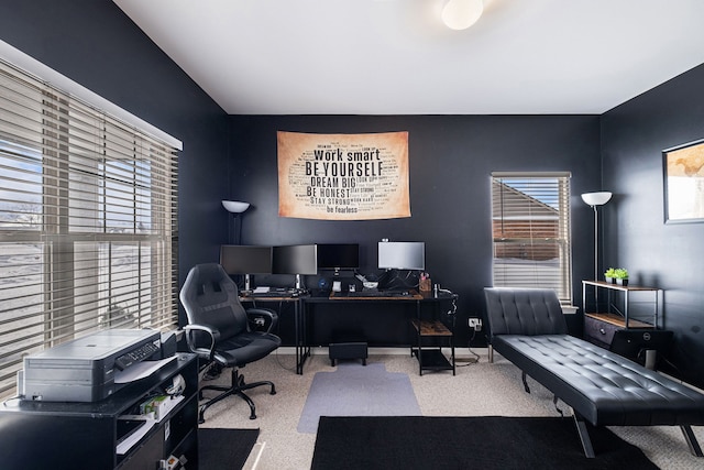 carpeted office space featuring baseboards