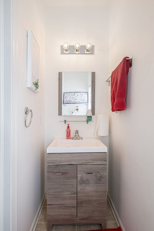 bathroom featuring baseboards and vanity