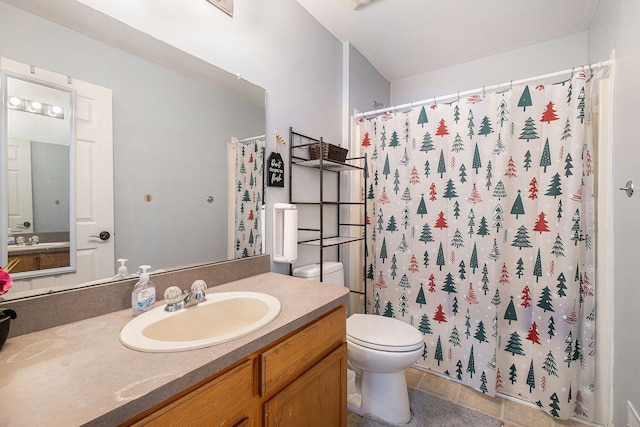 bathroom featuring curtained shower, tile patterned flooring, vanity, and toilet