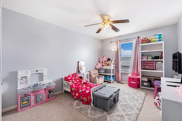 playroom featuring carpet, ceiling fan, and baseboards