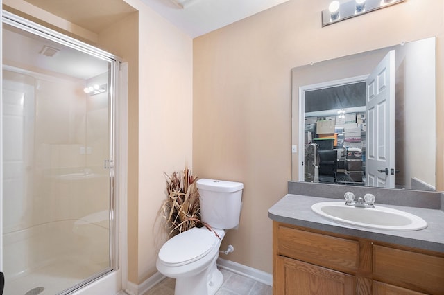 full bath featuring a stall shower, tile patterned flooring, vanity, and toilet