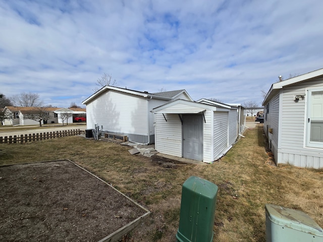 rear view of property with an outbuilding and a storage unit