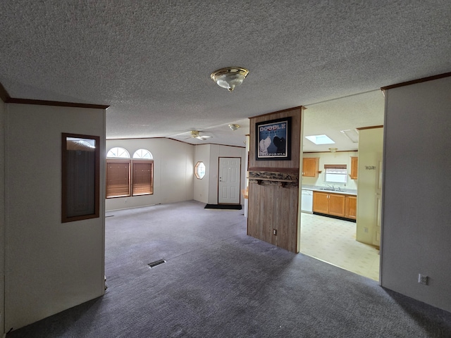 spare room with a skylight, visible vents, a wealth of natural light, and light colored carpet