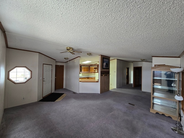 unfurnished living room with carpet, crown molding, a ceiling fan, and a textured ceiling