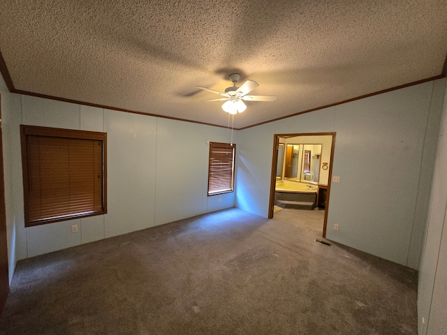 unfurnished room with ceiling fan, a textured ceiling, lofted ceiling, carpet, and crown molding