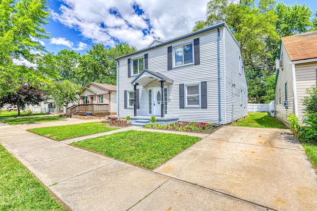 view of front of house featuring fence, a deck, and a front lawn