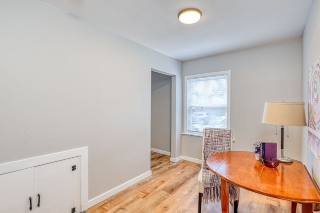 office with light wood-type flooring and baseboards