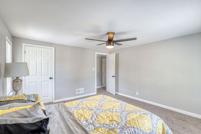 carpeted bedroom with ceiling fan, visible vents, and baseboards