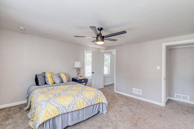 bedroom featuring carpet floors, a ceiling fan, visible vents, and baseboards