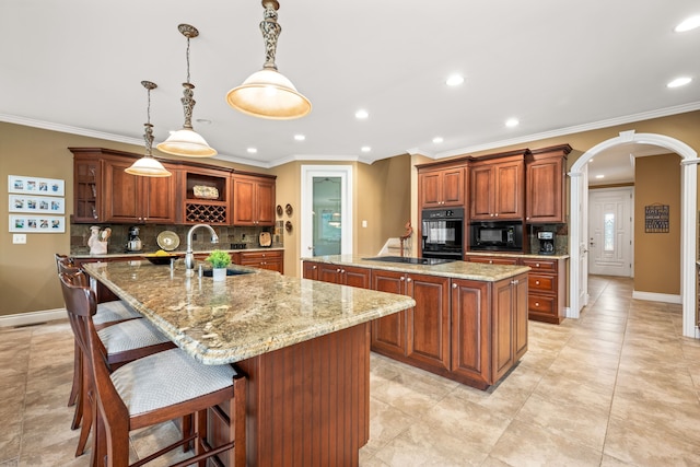 kitchen with arched walkways, open shelves, a sink, an island with sink, and black appliances