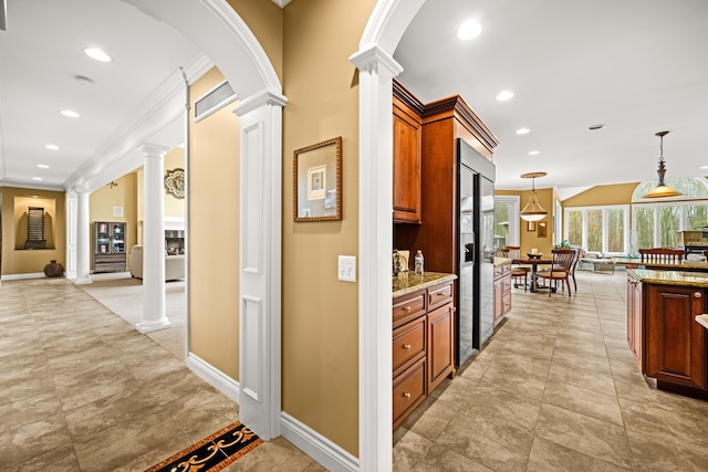 interior space with crown molding, recessed lighting, and decorative columns