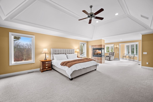 carpeted bedroom with recessed lighting, visible vents, baseboards, ornamental molding, and a tiled fireplace