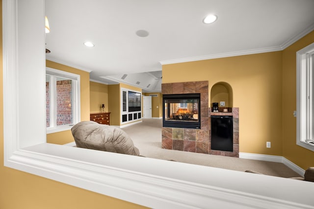 carpeted living room featuring plenty of natural light, baseboards, ornamental molding, and a tile fireplace