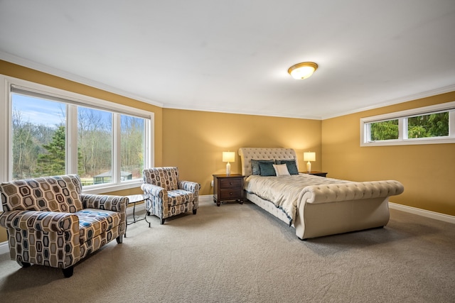 carpeted bedroom with ornamental molding and baseboards