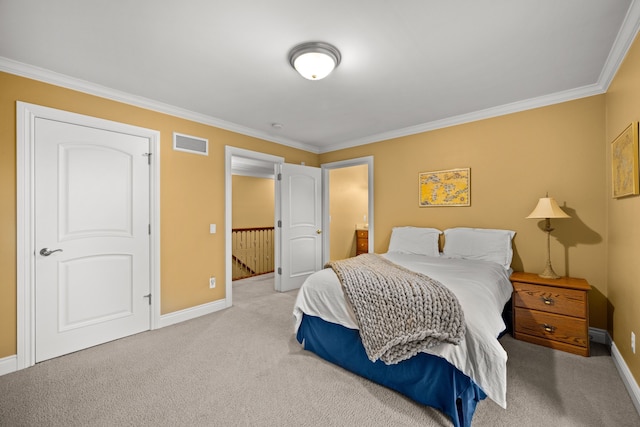 bedroom with baseboards, crown molding, visible vents, and carpet flooring