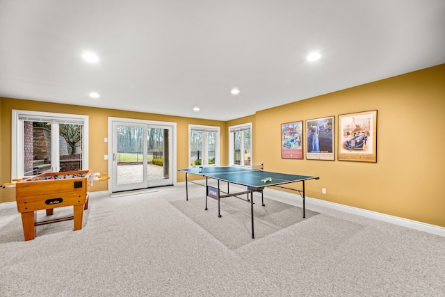 game room featuring recessed lighting, baseboards, and light colored carpet