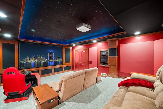 carpeted home theater room featuring a tray ceiling, visible vents, and recessed lighting