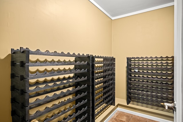 wine area featuring tile patterned flooring and crown molding