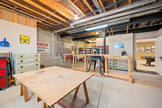 unfinished basement featuring billiards and a workshop area