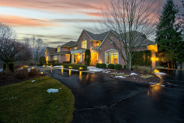 view of front of property with brick siding and driveway