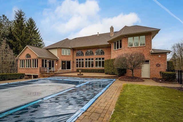 view of swimming pool with a patio area and a yard