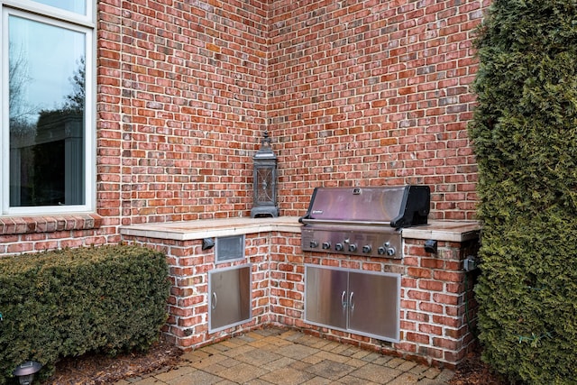 view of patio featuring area for grilling and a grill