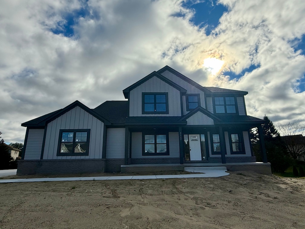 modern farmhouse style home with brick siding and board and batten siding