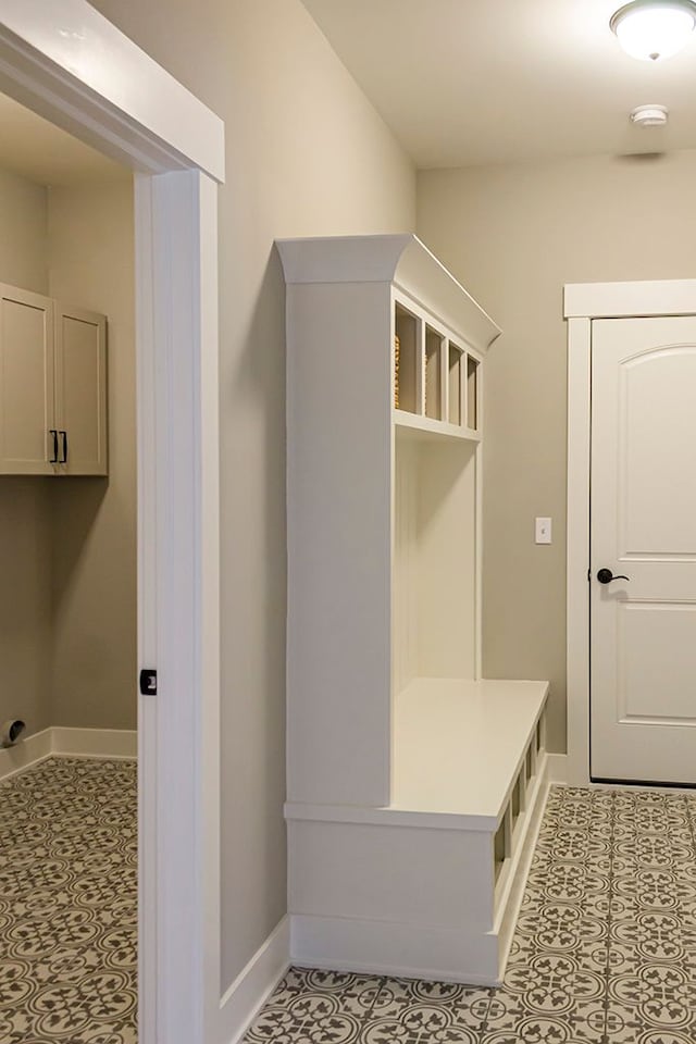 mudroom featuring light tile patterned floors and baseboards