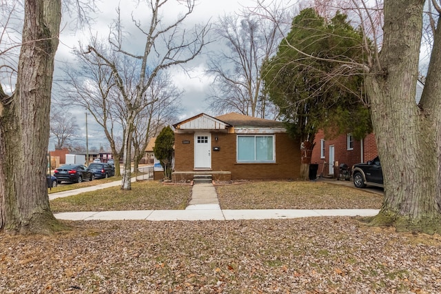 bungalow-style home with brick siding