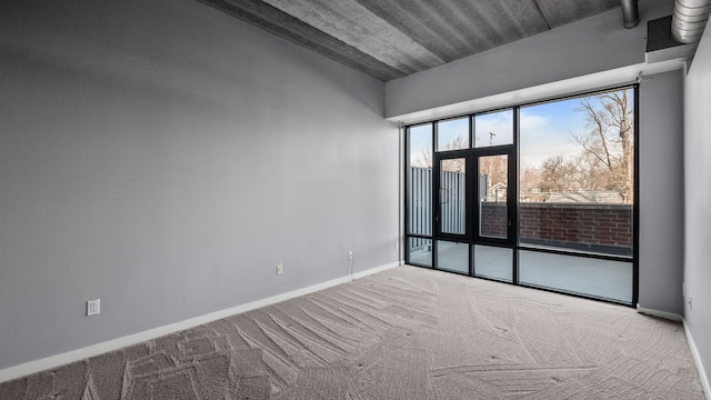 carpeted spare room with baseboards