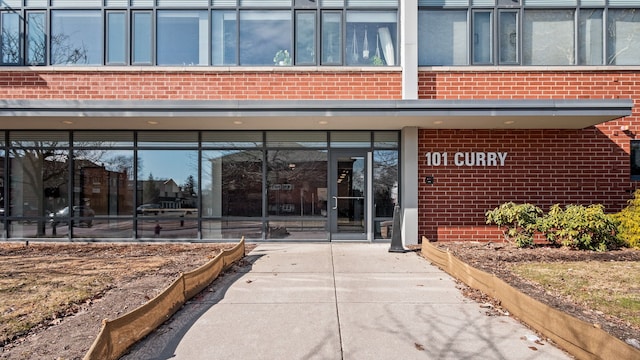 view of exterior entry with brick siding