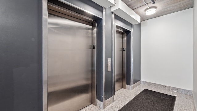 bathroom with speckled floor and elevator