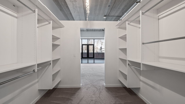 spacious closet featuring dark carpet