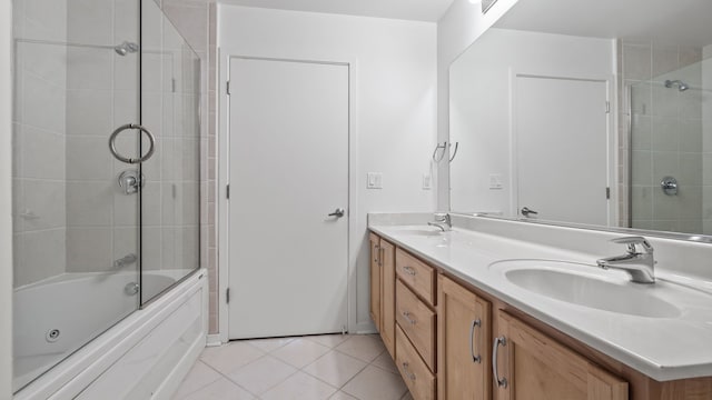 bathroom with double vanity, shower / bath combination with glass door, a sink, and tile patterned floors