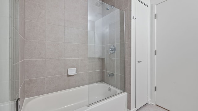 bathroom with combined bath / shower with glass door and tile patterned floors