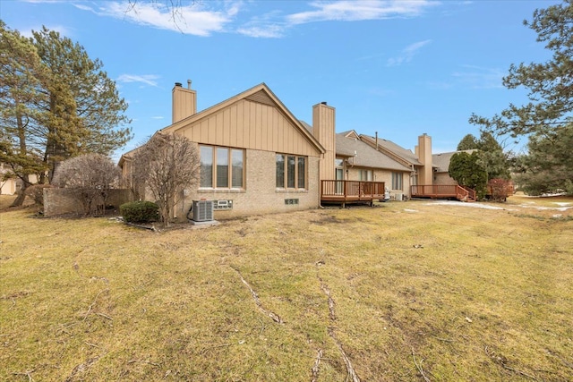 back of house featuring a yard, brick siding, central AC, and a wooden deck