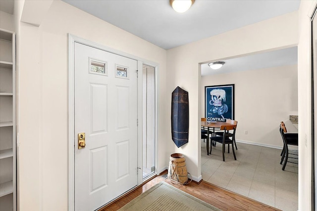 entrance foyer with baseboards and wood finished floors