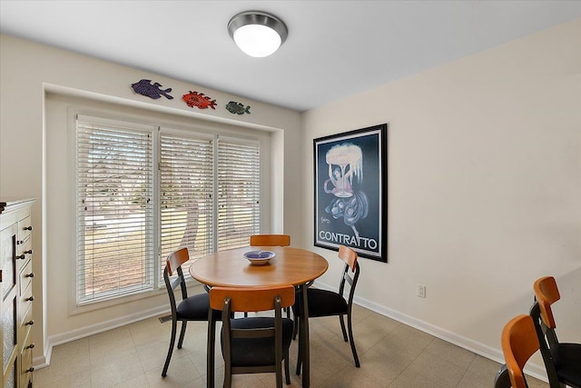 dining room with light floors and baseboards