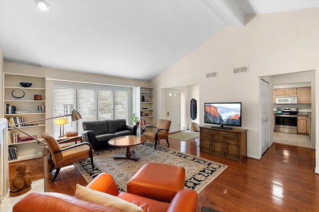 living room with beamed ceiling, built in features, visible vents, and light wood-style floors