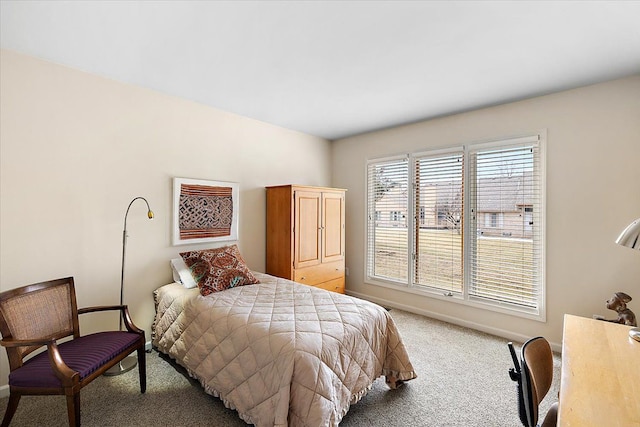 bedroom featuring light carpet and baseboards