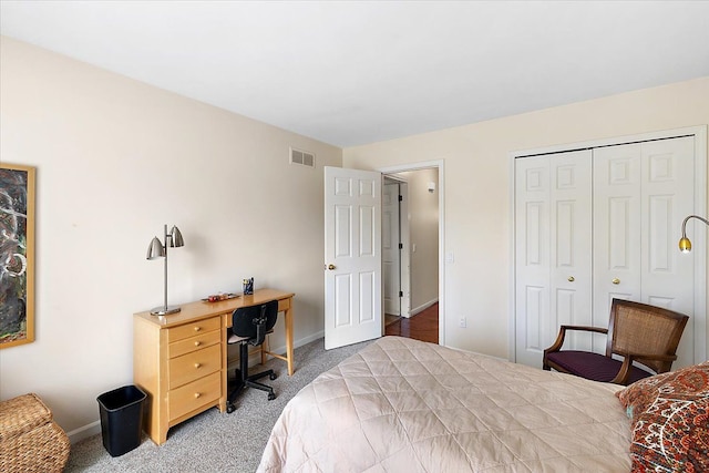 carpeted bedroom with baseboards, visible vents, and a closet