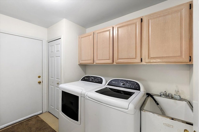 laundry room featuring separate washer and dryer, a sink, and cabinet space