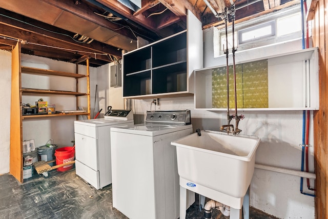 laundry area featuring a sink, laundry area, washing machine and clothes dryer, and electric panel