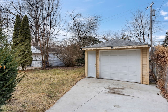 detached garage with driveway and fence