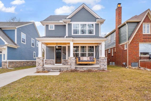 view of front of house with covered porch and a front lawn