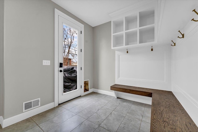 mudroom with baseboards, visible vents, and tile patterned floors