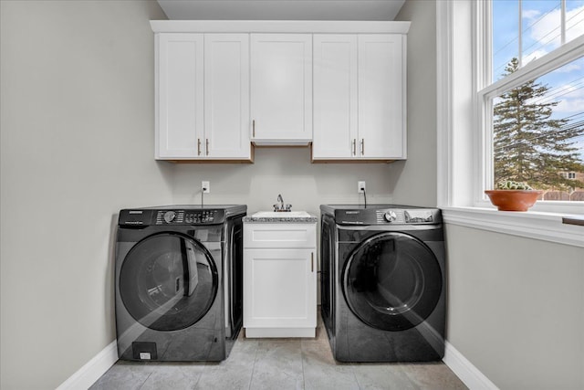 laundry room with a healthy amount of sunlight, cabinet space, and washer / clothes dryer