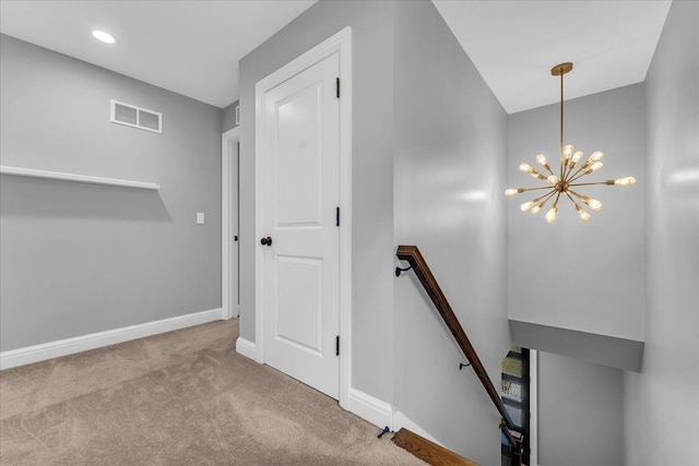 stairs with a notable chandelier, recessed lighting, visible vents, baseboards, and carpet